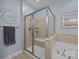 Close-up of the glass enclosed shower and soaking tub in the bathroom at 10206 Linksland Dr, Huntersville, NC 28078