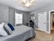Neutral bedroom with a gray quilted bedspread, window and ceiling fan at 10515 Royal Winchester Dr, Charlotte, NC 28277
