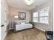 Day bed setup in a bedroom with a large window and accent floor lamp at 10515 Royal Winchester Dr, Charlotte, NC 28277