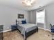 Bedroom featuring a black bed frame, complemented by gray walls and neutral carpet at 10515 Royal Winchester Dr, Charlotte, NC 28277