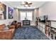 Comfortable bonus room features a ceiling fan, lots of natural light, shelving, and space for entertainment at 10515 Royal Winchester Dr, Charlotte, NC 28277