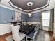 Elegant dining area featuring a large table, chandelier, and sophisticated wall decor at 10515 Royal Winchester Dr, Charlotte, NC 28277