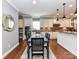 This dining room features a stylish table and flows seamlessly into the kitchen at 10515 Royal Winchester Dr, Charlotte, NC 28277