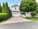 Charming two-story home featuring a two-car garage and a well-manicured front yard with mature landscaping at 10515 Royal Winchester Dr, Charlotte, NC 28277
