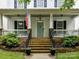 Close up of a beautiful front porch, stone accents, and a striking blue front door at 10515 Royal Winchester Dr, Charlotte, NC 28277