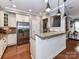 Well-lit kitchen features stainless appliances, granite countertops and white cabinetry at 10515 Royal Winchester Dr, Charlotte, NC 28277