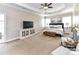 Spacious main bedroom with tray ceiling, TV, sitting area, and large windows offering ample natural light at 10515 Royal Winchester Dr, Charlotte, NC 28277