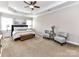 A beautifully lit main bedroom with ceiling fan, sitting area, and large windows for natural light at 10515 Royal Winchester Dr, Charlotte, NC 28277