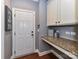 Functional mudroom with granite countertop and built-in cabinetry at 10515 Royal Winchester Dr, Charlotte, NC 28277