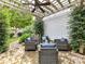Outdoor patio area with a pergola, seating, and landscaping at 10515 Royal Winchester Dr, Charlotte, NC 28277