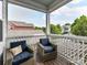 Screened porch with comfortable seating overlooking a residential neighborhood with lots of mature trees at 10515 Royal Winchester Dr, Charlotte, NC 28277
