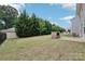 Spacious backyard featuring a lush green lawn and outdoor fireplace at 107 Sequoia St, Mooresville, NC 28117