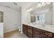 Elegant bathroom featuring double sink vanity, framed mirrors, and neutral tile flooring at 107 Sequoia St, Mooresville, NC 28117