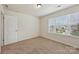 Bright bedroom with a window for natural light, neutral carpet, and a closet at 107 Sequoia St, Mooresville, NC 28117
