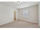 Bright bedroom with neutral walls and carpet featuring natural light from a window at 107 Sequoia St, Mooresville, NC 28117
