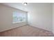 Bright bedroom featuring neutral carpet, a window with blinds, and neutral decor at 107 Sequoia St, Mooresville, NC 28117