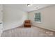 Cozy bedroom with a comfortable chair and plenty of natural light at 107 Sequoia St, Mooresville, NC 28117