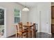 Cozy breakfast area featuring hardwood floors, a wooden table set, and natural light from a window at 107 Sequoia St, Mooresville, NC 28117