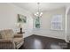 Bright dining room featuring hardwood floors, decorative molding, and a modern chandelier at 107 Sequoia St, Mooresville, NC 28117