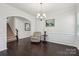 A dining room with wainscotting, dark wood floors, and neutral paint at 107 Sequoia St, Mooresville, NC 28117
