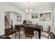A staged dining room featuring wainscotting, dark wood floors, and a chandelier at 107 Sequoia St, Mooresville, NC 28117
