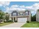 Charming two-story home with stone accents, neutral siding, a well-manicured lawn, and a two-car garage at 107 Sequoia St, Mooresville, NC 28117