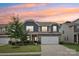 Charming two-story home with stone accents, neutral siding, a well-manicured lawn, and a two-car garage at 107 Sequoia St, Mooresville, NC 28117
