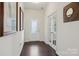 Elegant foyer with hardwood floors, decorative mirrors, and a glass-paned door at 107 Sequoia St, Mooresville, NC 28117