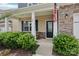 Inviting front porch with decorative stone, American flag, and stylish seating area at 107 Sequoia St, Mooresville, NC 28117