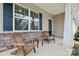Inviting front porch featuring a stone accent wall and comfortable wooden seating arrangement at 107 Sequoia St, Mooresville, NC 28117