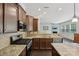 Bright kitchen with stainless steel appliances, granite countertops, dark cabinets, and hardwood flooring at 107 Sequoia St, Mooresville, NC 28117