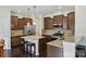 Kitchen with stainless appliances, granite countertops, dark cabinets, and breakfast bar with seating at 107 Sequoia St, Mooresville, NC 28117