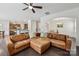 Spacious living room featuring a leather sectional sofa, ceiling fan, and hardwood flooring at 107 Sequoia St, Mooresville, NC 28117