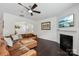 Cozy living room featuring a fireplace, hardwood floors, and a stylish ceiling fan at 107 Sequoia St, Mooresville, NC 28117