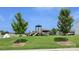 Community playground featuring slides, climbing structures, and a picnic shelter on a well-maintained green lawn at 107 Sequoia St, Mooresville, NC 28117