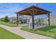 Community playground featuring a picnic pavilion, play structure, and a 'Little Free Library' on a sunny day at 107 Sequoia St, Mooresville, NC 28117