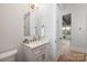 Chic powder room with a stylish mirror, modern vanity, and elegant fixtures at 111 Monbo Meadows Ln, Statesville, NC 28677