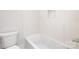 Tiled bathroom featuring a white tub and toilet at 111 Monbo Meadows Ln, Statesville, NC 28677
