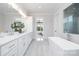 Elegant bathroom with a soaking tub, walk-in shower, and dual sink vanity at 111 Monbo Meadows Ln, Statesville, NC 28677