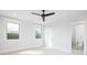 Bright bedroom with large windows, ceiling fan, and ensuite bathroom entrance at 111 Monbo Meadows Ln, Statesville, NC 28677