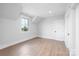 Cozy bedroom featuring a window, trim accents, and light wood flooring at 111 Monbo Meadows Ln, Statesville, NC 28677