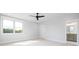 Bright bedroom with large windows, ceiling fan, and ensuite bathroom entrance at 111 Monbo Meadows Ln, Statesville, NC 28677