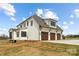 Rear exterior view showing the home's three-car garage and yard at 111 Monbo Meadows Ln, Statesville, NC 28677