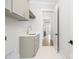 Clean laundry area with sink, cabinets, and a view to other rooms at 111 Monbo Meadows Ln, Statesville, NC 28677