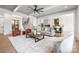 Open-concept living room featuring modern decor and an open view of the kitchen and staircase at 111 Monbo Meadows Ln, Statesville, NC 28677