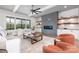 Bright living room featuring a modern fireplace, shelving, and a large window with scenic views at 111 Monbo Meadows Ln, Statesville, NC 28677