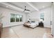 Bright main bedroom featuring a ceiling fan, natural light, and hardwood floors at 111 Monbo Meadows Ln, Statesville, NC 28677
