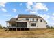 View of the rear exterior featuring a screened porch and an open porch overlooking the backyard at 111 Monbo Meadows Ln, Statesville, NC 28677