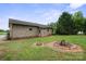 Rustic home featuring a backyard with a fire pit surrounded by lush greenery at 112 Gays Chapel Rd, Statesville, NC 28625