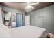 This is a bedroom with painted paneling, a ceiling fan, and doorways to other rooms at 112 Gays Chapel Rd, Statesville, NC 28625